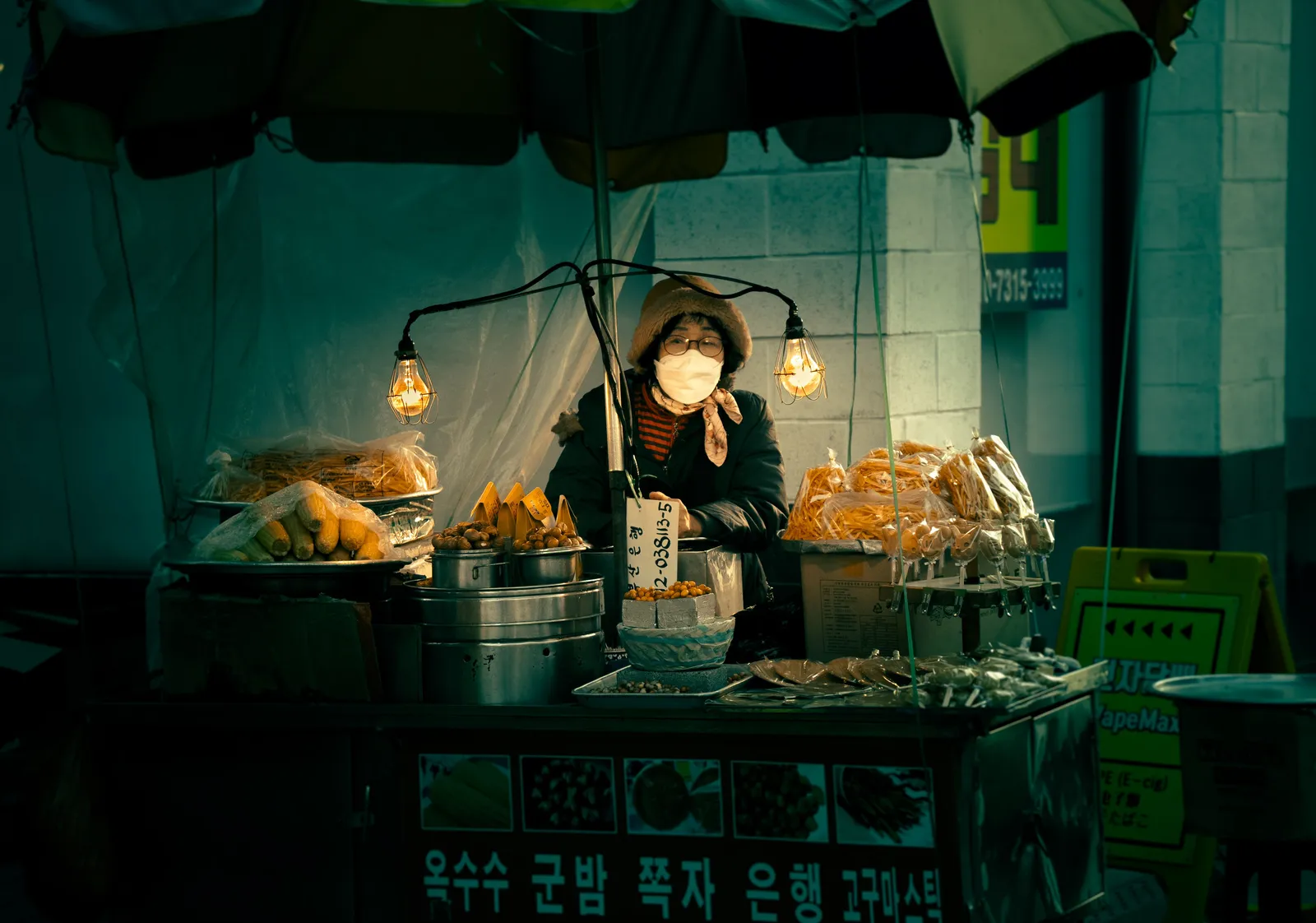 A market food stall with a vendor preparing fried snacks in Andong, South Korea