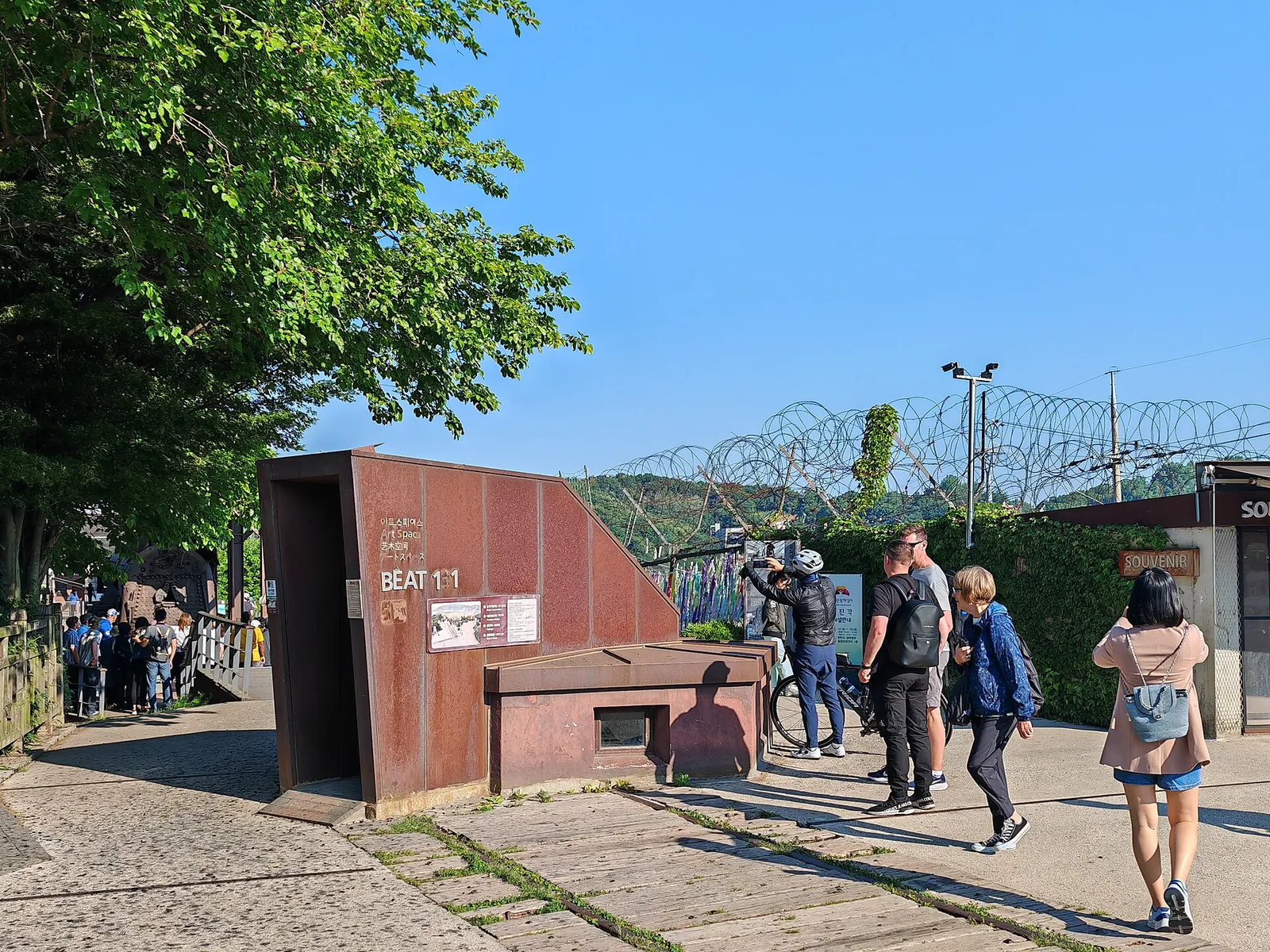 Visitors at a viewing area beside a wire fence near the demilitarised zone, South Korea