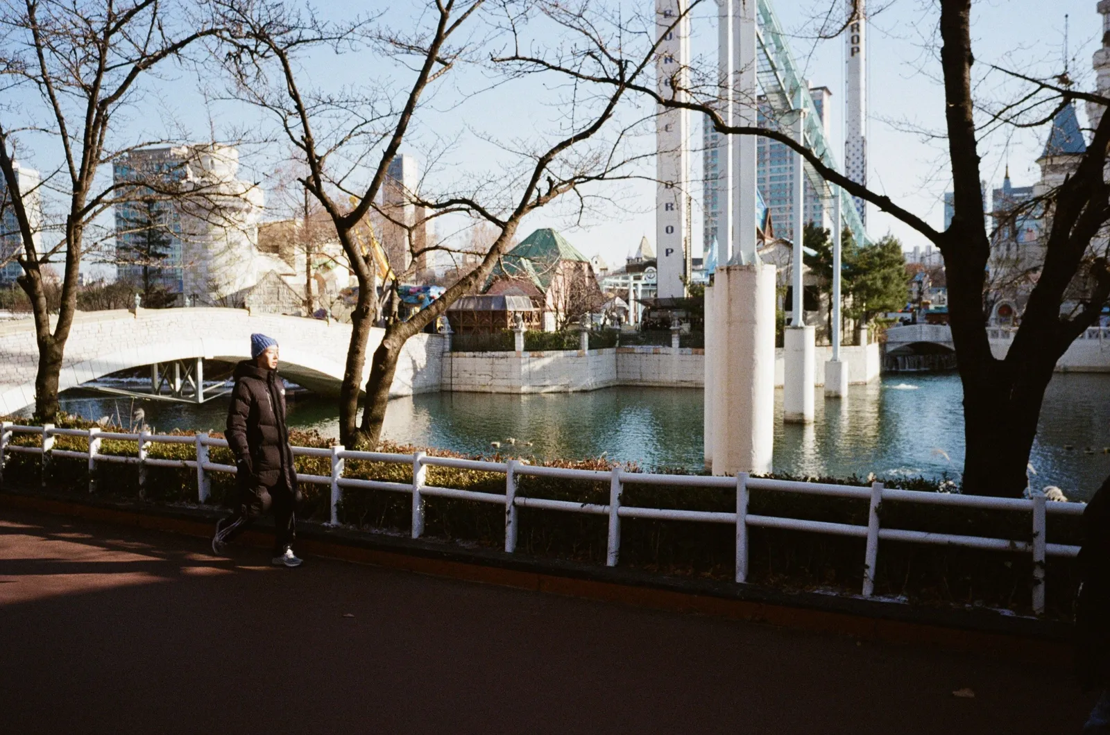 A theme park entrance with crowds walking towards the gates in South Korea