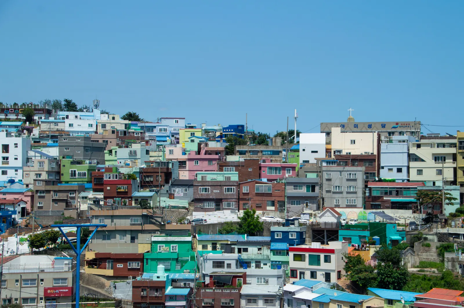 A view across the colourful rooftops of the hillside village towards the sea in Busan, South Korea