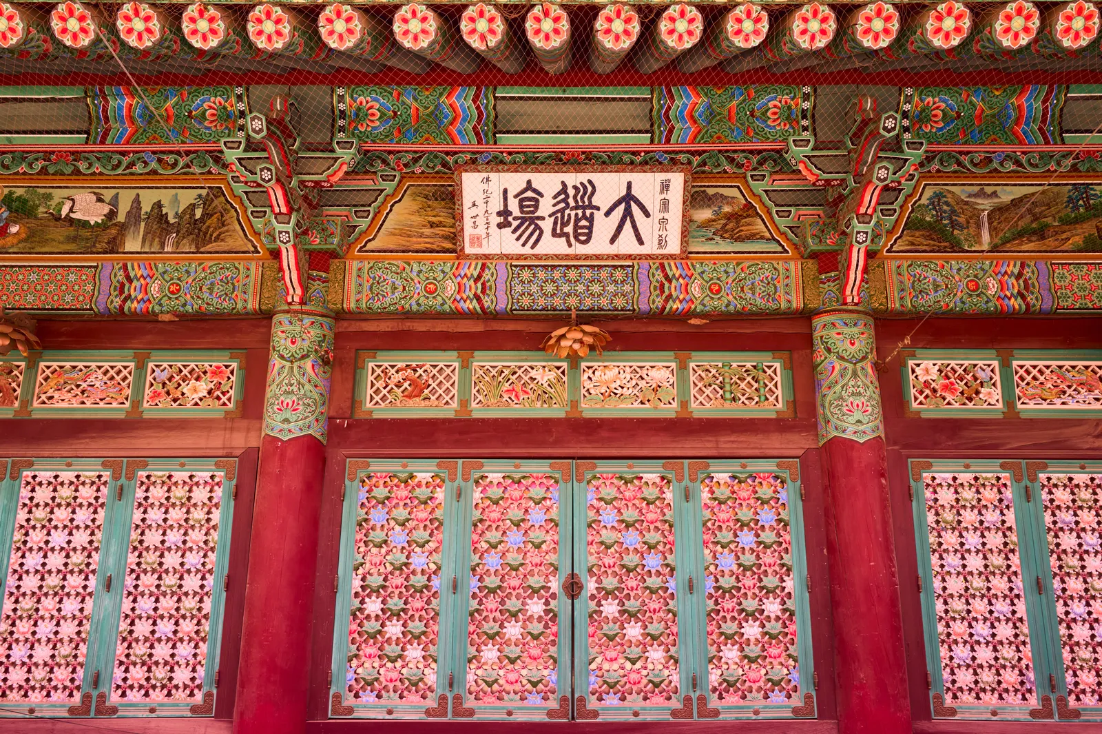 The painted gate of a Korean temple with decorated doors near Gyeongju, South Korea