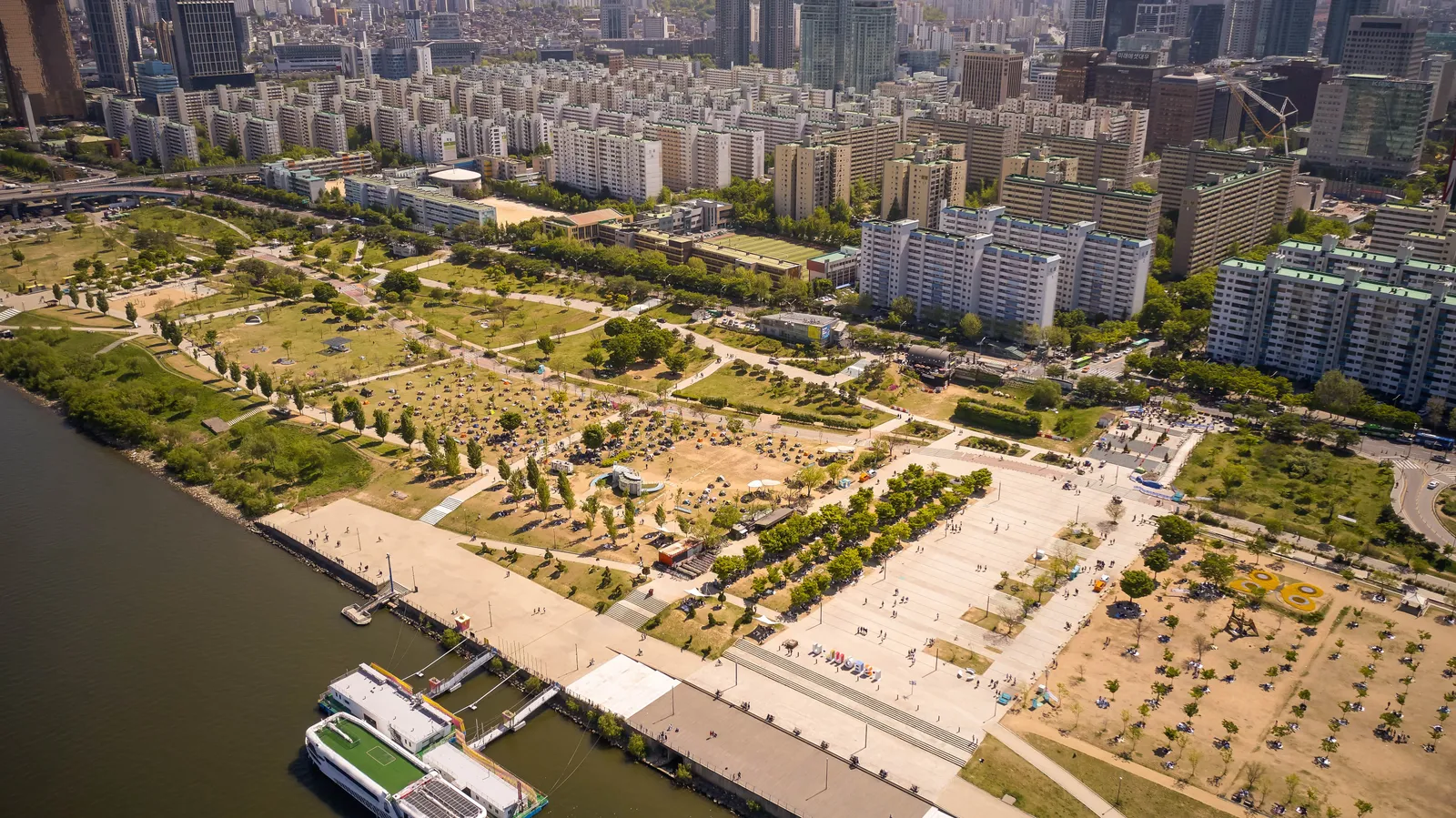 An aerial view of a riverside park along the Han River in Seoul, South Korea