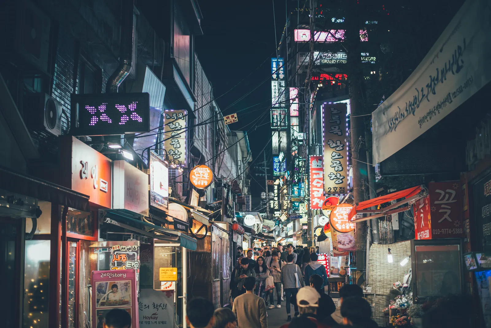 A lantern-lit alley of bars and street food stalls at night in Seoul, South Korea
