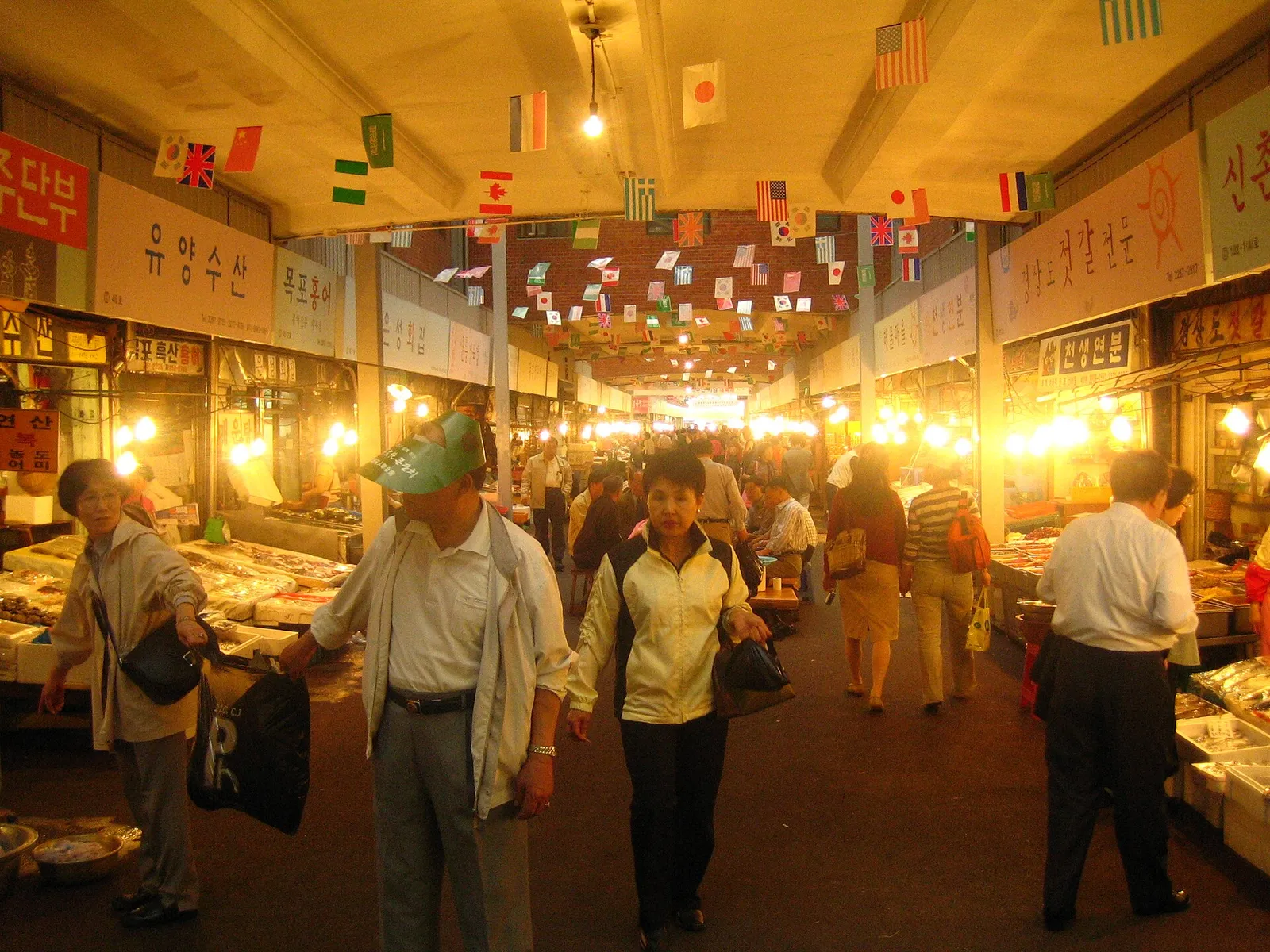 Busy food stalls and diners at Gwangjang Market in Seoul, South Korea