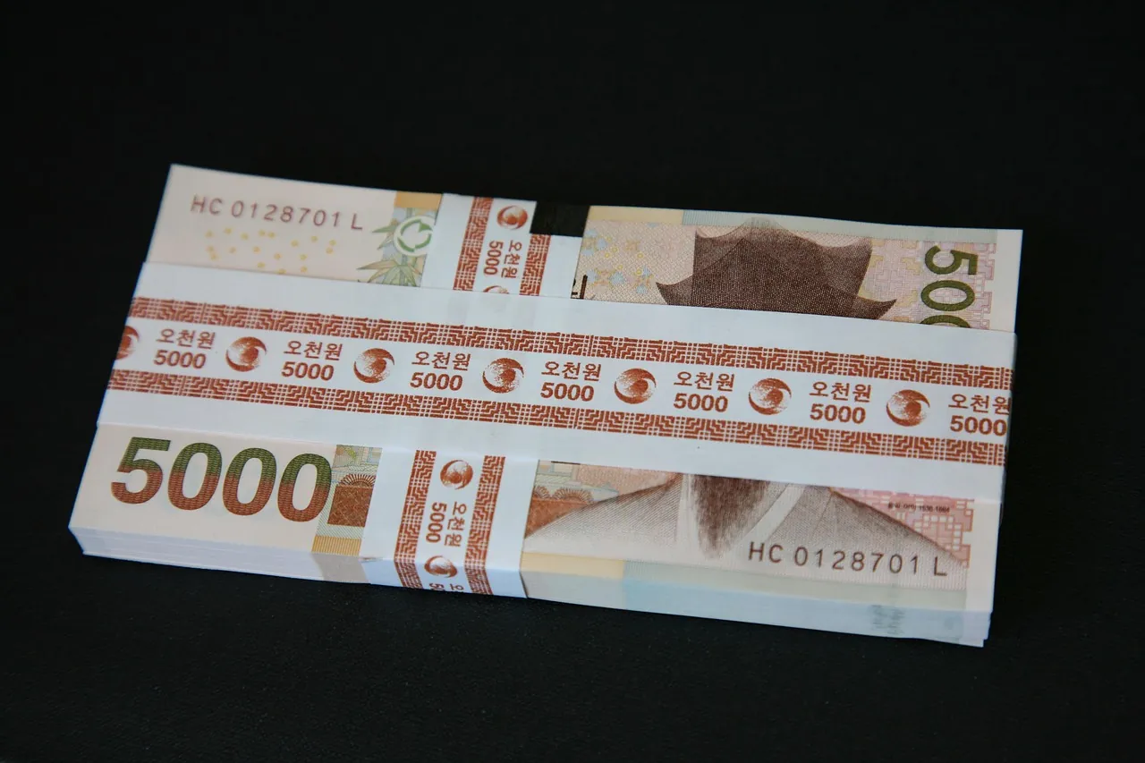 Bundled five thousand won banknotes on a dark surface, South Korea
