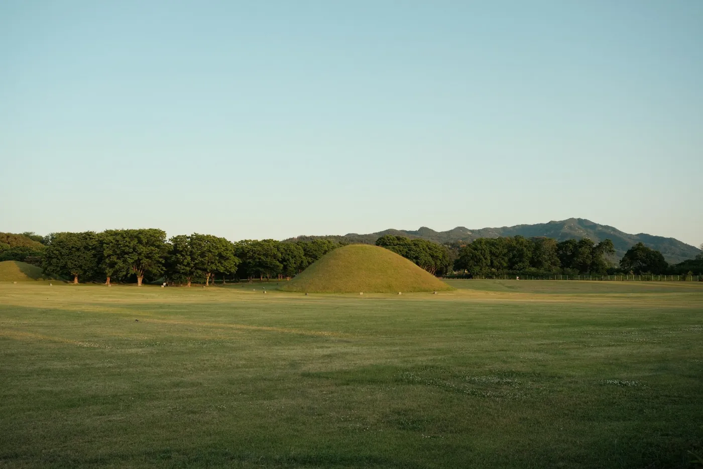 Ancient royal burial mounds in a grassy park in central Gyeongju, South Korea