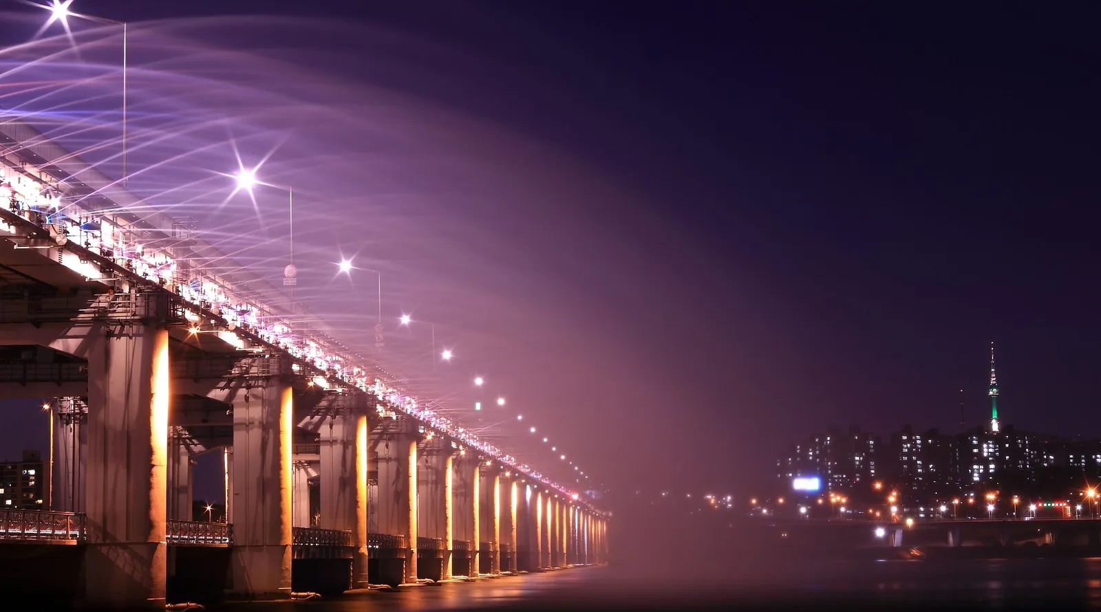 The Banpo Bridge lit up above the Han River at night in Seoul, South Korea