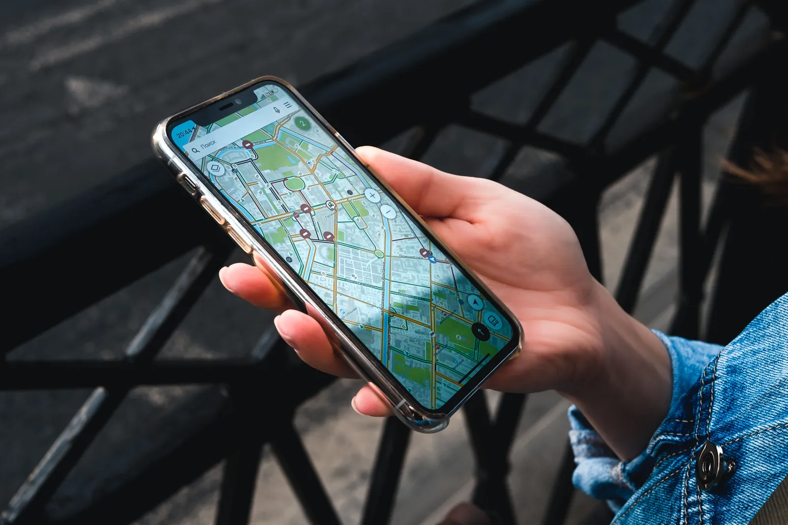 A hand holding a phone displaying a street map, South Korea