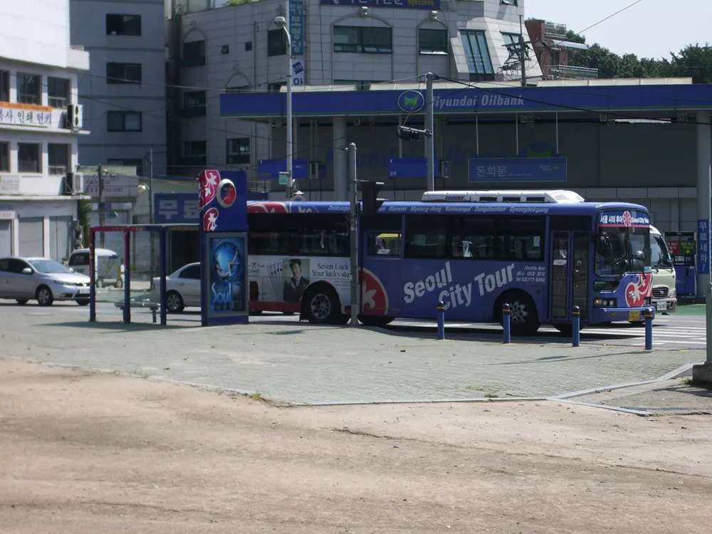 A Seoul city bus at a stop on a street in South Korea