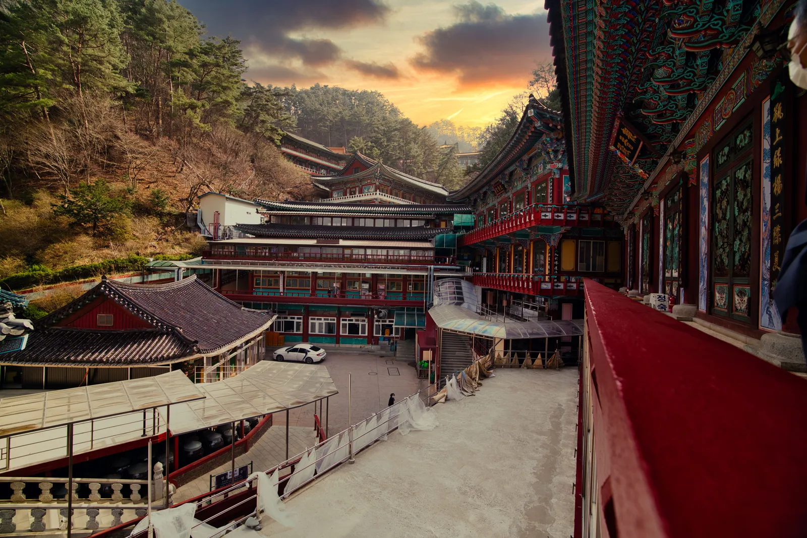 A mountain Buddhist temple with wooden halls among forested peaks in South Korea