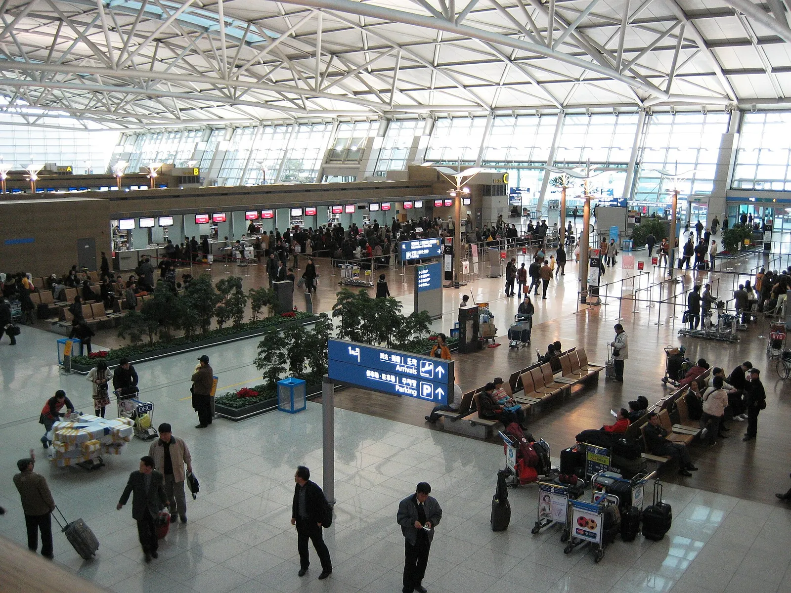 The bright check-in hall of Incheon International Airport in South Korea with departure counters and travellers