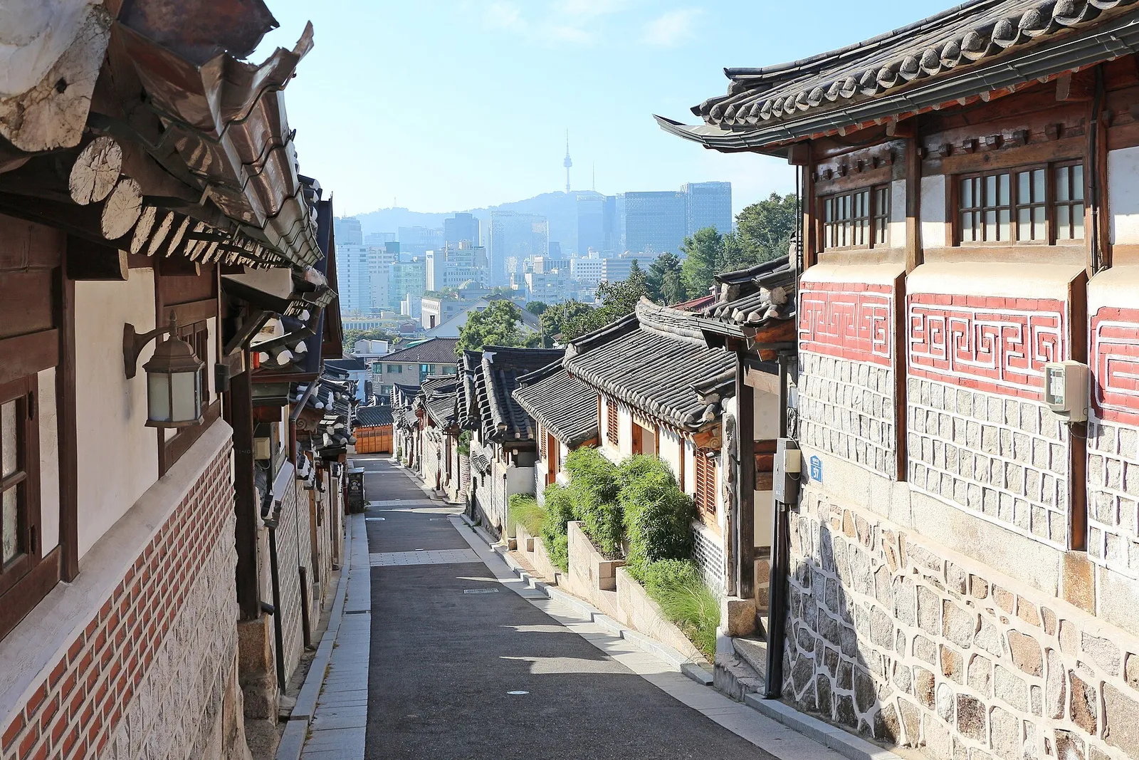 Traditional tiled roofs and narrow lanes of Bukchon Hanok Village in Seoul, South Korea, on a clear day