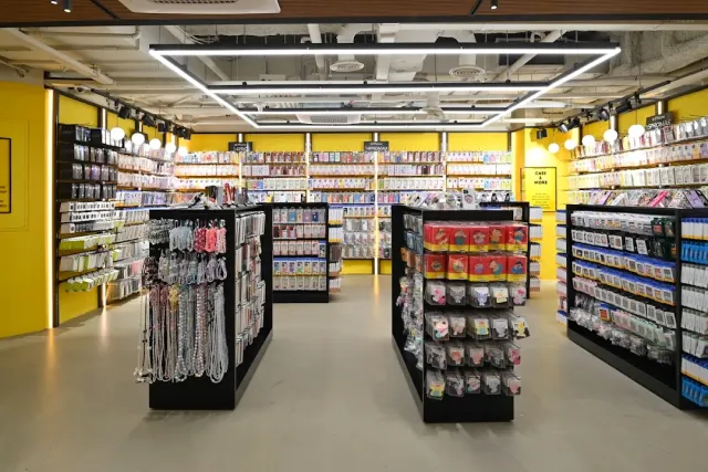 A shop with yellow walls and shelves packed with phone cases and small accessories