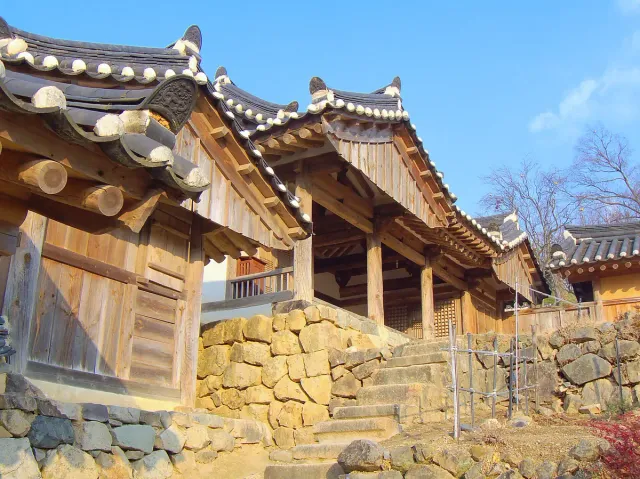 Traditional noble houses with tiled roofs on stone terraces along a slope