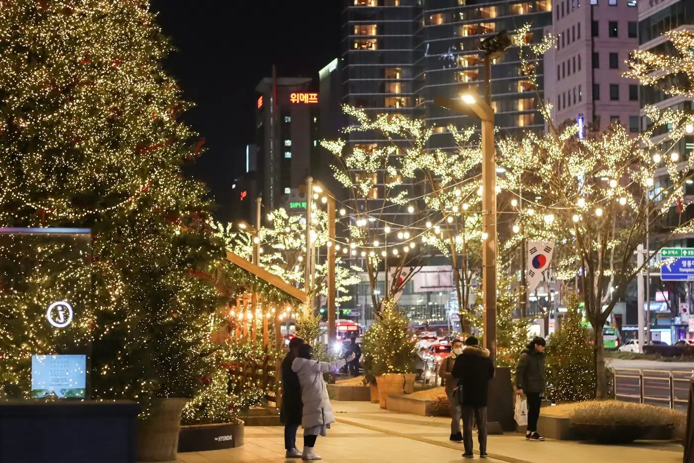 A street lined with illuminated trees and Christmas lights in Seoul on a winter evening, South Korea