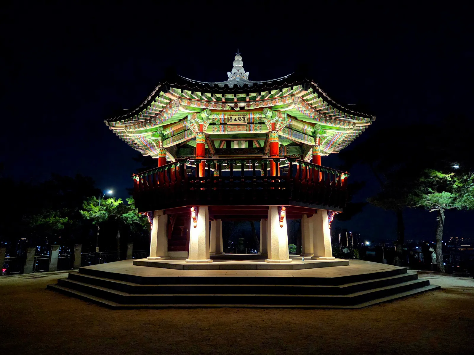 Crowds gathered near the illuminated Bosingak bell pavilion in central Seoul on a winter evening, South Korea
