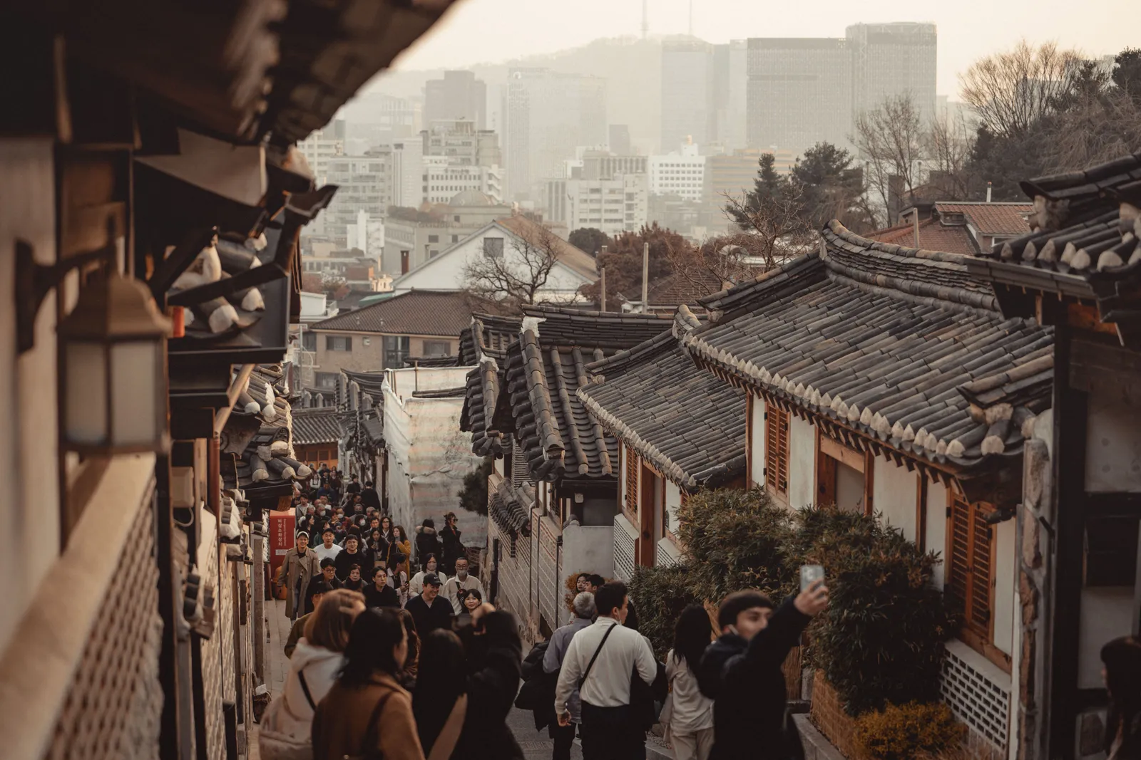 Traditional tiled-roof hanok houses on a quiet sloping alley in the Bukchon village of Seoul, South Korea
