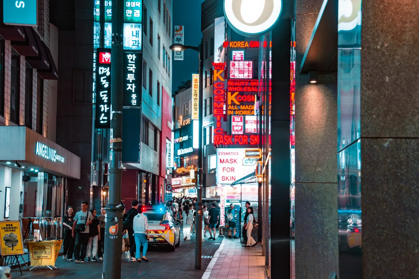 The evening crowd on a Myeongdong street in Seoul under neon signs