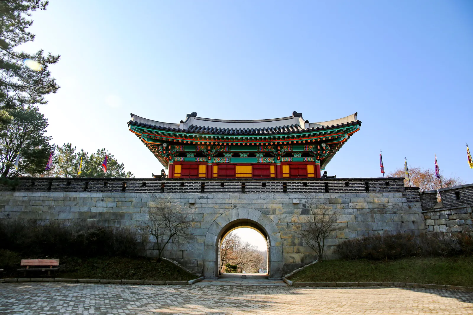 A fortress gate with a tiled pavilion above the arch in Suwon, South Korea