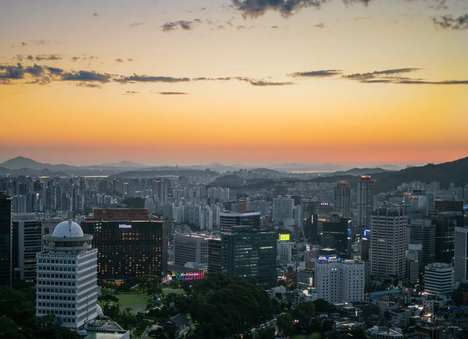 The Seoul skyline at golden hour seen from a hilltop viewpoint in South Korea