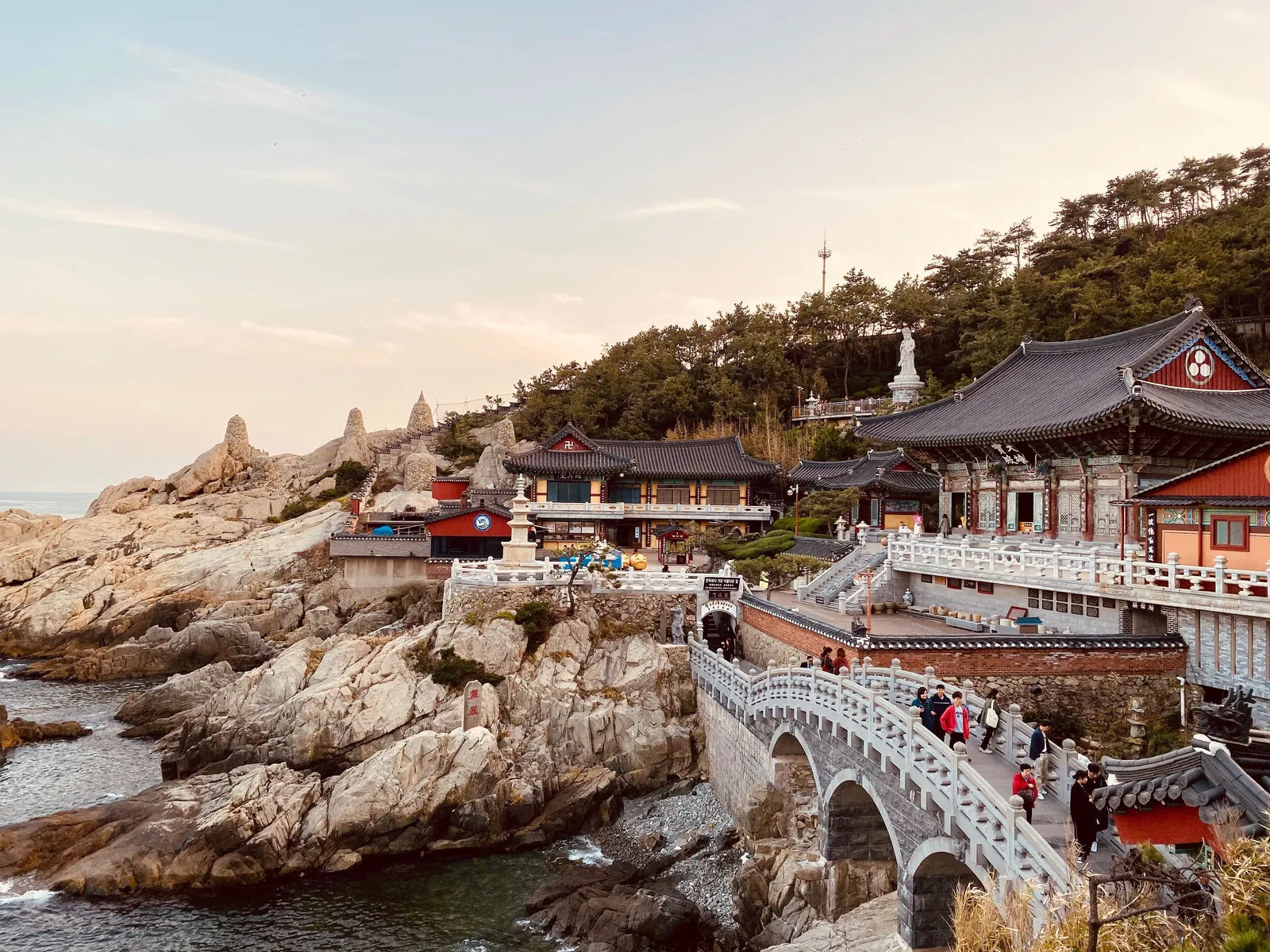 The halls and stone bridge of Haedong Yonggungsa temple built on rocks above the sea, Busan, South Korea